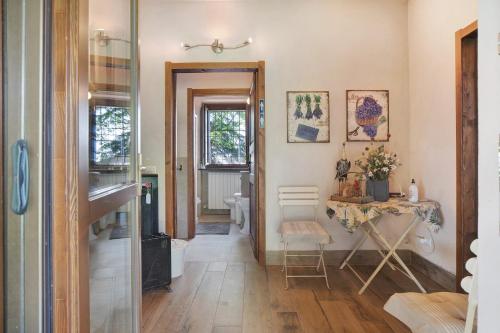 a hallway with a table and a sink in a room at Cascina Brignolo - Casa Bianca in Novara