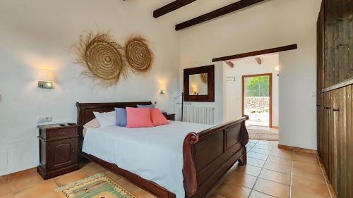 a bedroom with a large bed and a mirror at Villa Radi by Eivillas in Santa Gertrudis de Fruitera