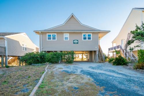 a house with a driveway in front of it at Lady Dune in Oak Island
