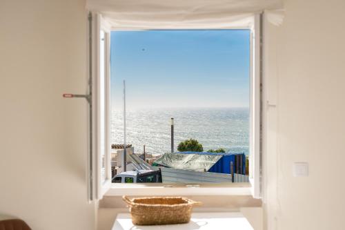 an open window with a view of the ocean at Horizonte Azul - New Renovated with Sea View in Nazaré