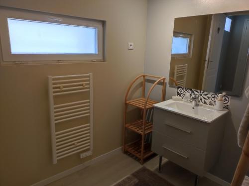 a bathroom with a sink and a mirror at GITE "LE VALLON DE PARAY" in Paray-le-Monial
