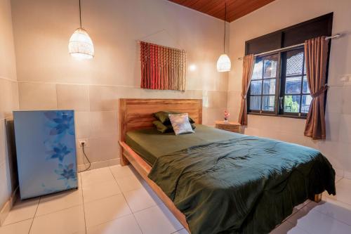a bedroom with a bed and a window at Komala Indah 2 in Badung