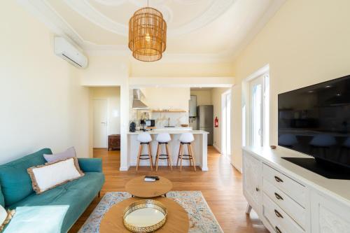 a living room with a blue couch and a table at Horizonte Azul - New Renovated with Sea View in Nazaré
