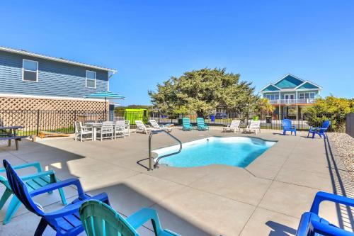 a swimming pool with blue chairs and a slide at Life Is Good in Oak Island