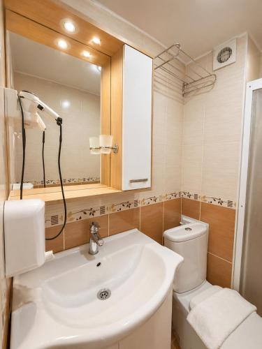 a bathroom with a sink and a toilet and a mirror at Le Safran Palace in Istanbul