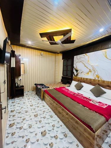 a bedroom with a large bed with a painting on the wall at Krishna Villa in Varanasi