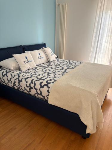 a bed with pillows on it in a bedroom at Casalura in Polignano a Mare