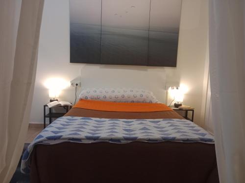 a bedroom with a large bed with two lamps at Loft Centrico - Bahia 2B in Santander