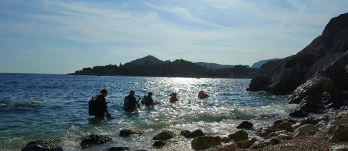 a group of people standing in the water at Apartments Grbic in Mlini