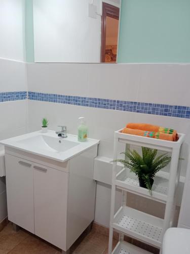 a white bathroom with a sink and a mirror at Loft Centrico - Bahia 2B in Santander