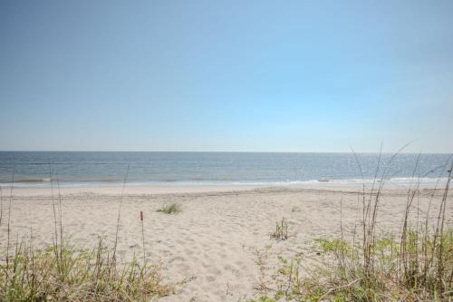 a sandy beach with the ocean in the background at Linger Longer in Caswell Beach
