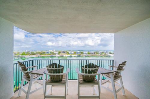 a balcony with a table and chairs and a view of the water at Wind Drift 615N condo in Orange Beach