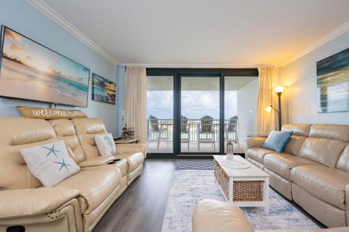a living room with a couch and a table at Wind Drift 615N condo in Orange Beach