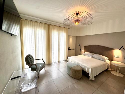 a bedroom with a bed and a glass table at Hotel Blu Corallo in Marina Romea