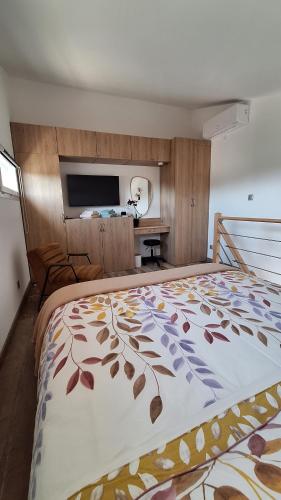a bedroom with a large bed with avertisementatronatronstrationstrationstration at Petite Maison indépendante. in Béziers