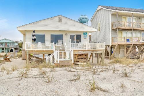 a house on the beach with a lighthouse at Lisa Lu in Oak Island