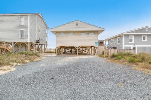 a house and a barn next to some houses at Lisa Lu in Oak Island
