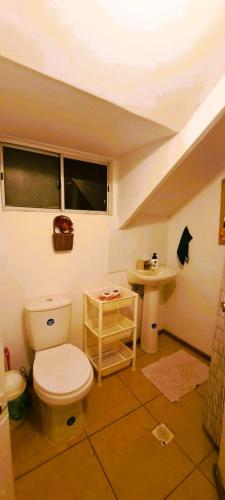 a bathroom with a toilet and a sink at Hare Te Maori in Hanga Roa