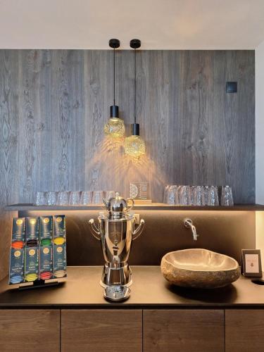 a bathroom with a counter with a sink and a bowl at Residence Gloria Dei in Schenna