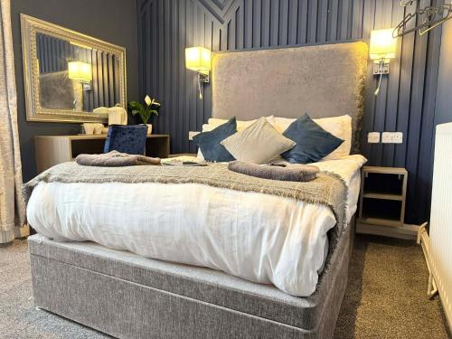 a bedroom with a large bed with pillows on it at The Jubilee Hotel East - with NEWLY REFURBISHED SPA FACILITIES - GAMESPIT - AND SMOKEHOUSE in Weymouth