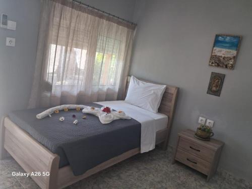 a small bedroom with a bed and a window at Irina's Stoudio 7 in Psakoudia
