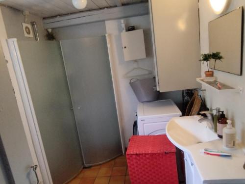 a small kitchen with a sink and a washing machine at Small House ærø in Marstal