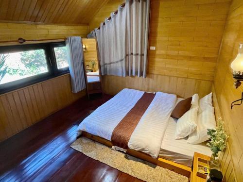 a bedroom with a bed in a room with a window at tiny house in Ấp An Kroët