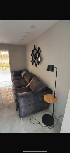 a living room with a leather couch and a table at קשת בענן in Eilat