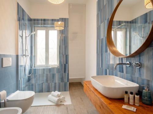 a bathroom with a tub and a sink and a mirror at Casa Bambu in Polignano a Mare
