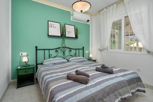 a bedroom with a large bed with two pillows on it at Apartamento Bellavista Torrox Park in Torrox