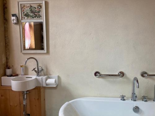 a bathroom with a sink and a bath tub at beachhousebarn in Vendays-Montalivet