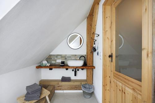 a bathroom with a sink and a wooden door at Beim Senner in Halblech
