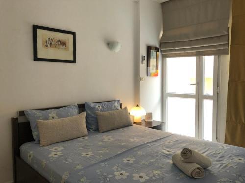 a bedroom with a bed with two towels on it at Waterside in Hammam Sousse