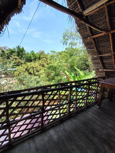 a balcony with a view of a forest at Search hurt stays in Kuilapayam