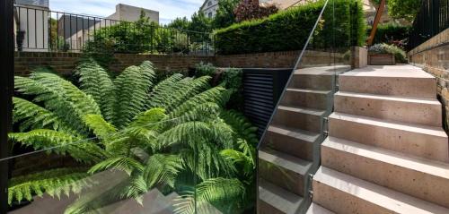 a bunch of plants on the side of some stairs at Elegant Luxury Flat Regent s Park in London