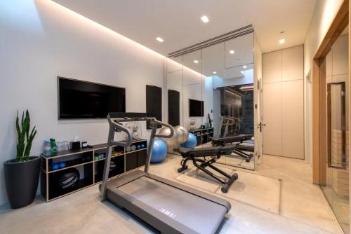 a gym with two exercise bikes and a television at Elegant Luxury Flat Regent s Park in London