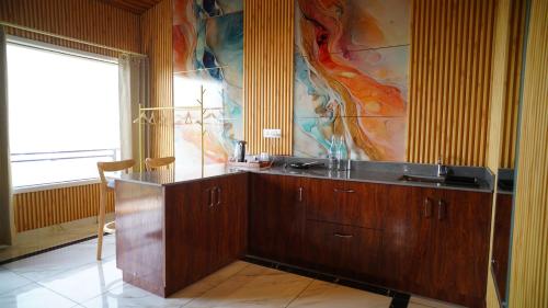 a bathroom with a sink and a painting on the wall at Msk Hotel & Restaurant in Narendranagar