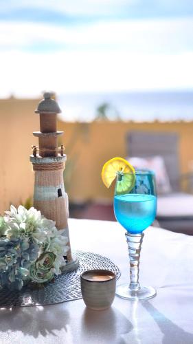 a blue drink in a glass on a table at Thelighthouse Porto Santo in Porto Santo