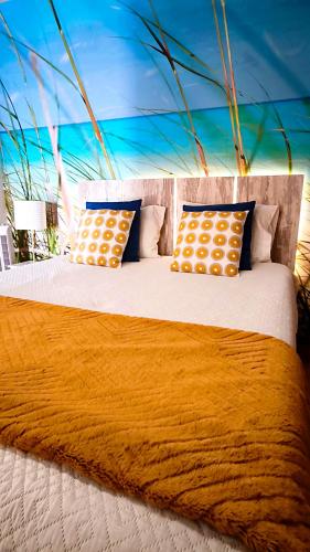 a large bed with two pillows on top of it at Thelighthouse Porto Santo in Porto Santo