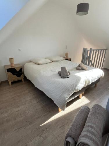 a bedroom with a large bed in a room at Les 3 conserveries in Le Crotoy
