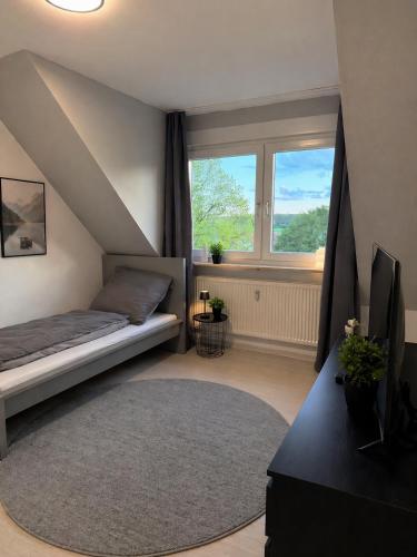 a bedroom with a bed and a large window at Apartment Kist bei Würzburg in Kist