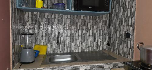 a kitchen counter with a sink in a kitchen at Résidence BEDEL in Yamoussoukro