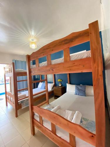 a bedroom with two bunk beds in a room at Blue Water De Santorini in Puerto Galera