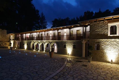 a building lit up at night with lights at Frontzu Politia in Ioannina