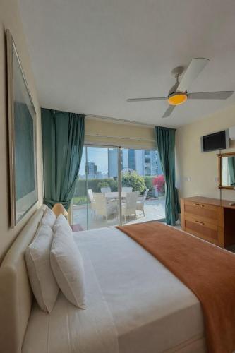 a bedroom with a large bed with a large window at Bayview Terraces Cozy 1BR Haven in Limassol