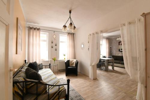 a room with a bed and a living room at Ferienwohnung Schwarz & Weiß in Eisenach