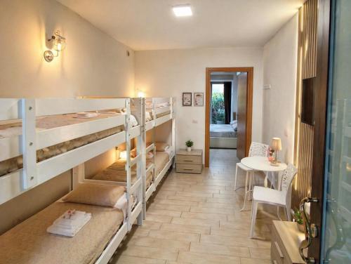 a room with two bunk beds and a table at Affittacamere Silvagni in Caserta