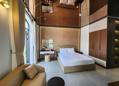a bedroom with a bed and a couch at DOS GATOS Hotel in Ðố Sơn