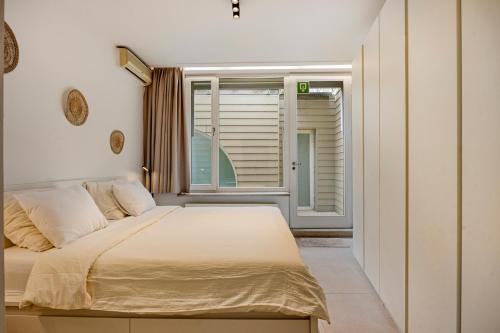 a bedroom with a large bed and a window at Markt 5 in Lier