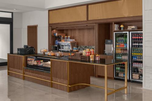 a restaurant with a counter with food and drinks at The Waymark Chattanooga, Tapestry Collection By Hilton in Chattanooga
